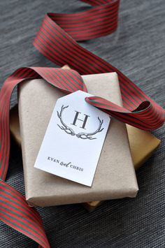 a gift wrapped in brown paper with a red ribbon