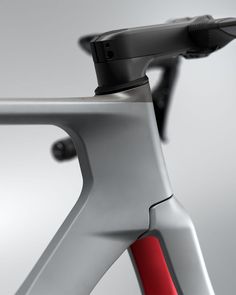 the front end of a bike with a red handlebar