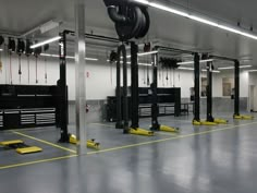 the inside of a garage with several different types of equipment and colors on the floor