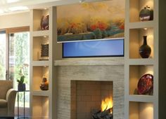 a living room filled with furniture and a fire place in front of a flat screen tv