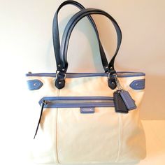 Coach Daisy Spectator Emma Genuine Leather Cream, Navy And Medium Blue Tote With Double Handles And Zip Closure. Cream Satin Dust Cover Included! Details: Smooth Genuine Leather Cream Body Navy And Medium Blue Trim Zip-Top Closure Front: Zip Pocket Back: Open Pocket Inside: Navy Satin Lining / 1 Zip And 2 Multifunction Pockets Approx. Dimensions: 16" (W) X 12.5" (H) X 4" (D) Handle Drop 8.5" Excellent Condition, Never Worn Nwot Smoke-Fee Home Same Or Next Day Shipping Office Bags In Cream With Zipper Closure, Cream Office Bag With Zipper Closure, Cream Office Bags With Zipper Closure, Cream Coach Bags For Office, Office Shoulder Bag With Cream Leather Handles, Cream Shoulder Bag With Leather Handles For Office, Classic Cream Shoulder Bag, Coach Beige Office Bags, Beige Coach Satchel For Everyday