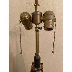 an old fashioned lamp with two lamps attached to it