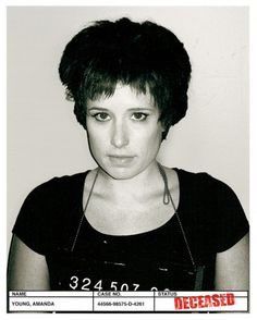 a black and white photo of a woman with short hair