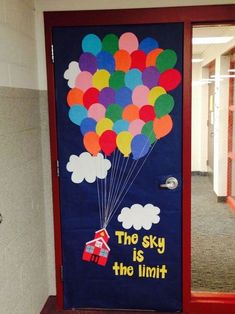 a door decorated with balloons and the words the sky is the limit