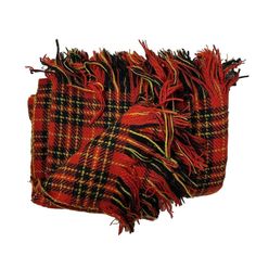 three pieces of red and black plaid fabric with fringes on the ends, one is folded