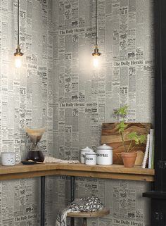 a kitchen with newspaper wallpaper and wooden counter tops, along with potted plants