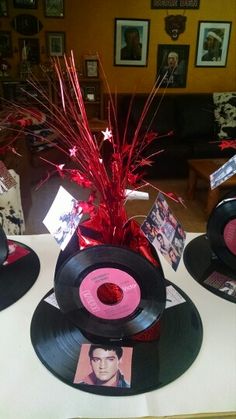 three records are sitting on top of a table with pictures and decorations around them in the shape of hats