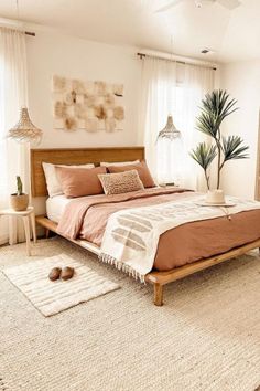 a bedroom with a bed, rugs and two lamps on the side of the room