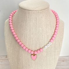 Your little one will love to accessorize with this cute heart necklace! It is made with matte pink beads and a heart charm. It will make any outfit more special! Personalize it with any name :-) This stretchy necklace fits right over your head so it's easy to put on- no clasps needed. 🤍 Please check all selections and spelling prior to check out. Our custom jewelry is made to order so all sales are final. 🤍 The necklace is beautifully packaged and ready to gift. Receipts are never included. If Pink Heart Necklace, Best Valentine Gift, Valentine Gifts For Kids, Heart Charm Necklace, Valentine Gifts For Girlfriend, Valentines Gifts For Boyfriend, Matte Pink, Concert Fits, Beaded Pendant Necklace