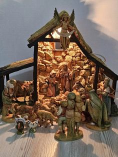 a nativity scene with figurines in the shape of a house