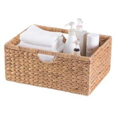 a wicker basket with towels and soaps in it