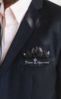 a man wearing a pinstripe suit and tie with his name on the lapel