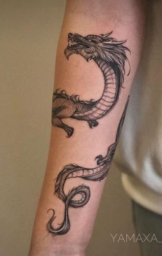 a man's arm with a dragon tattoo on it