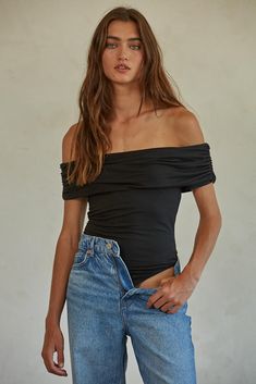 Introducing the Luxe Bodysuit - made with a luxurious blended fabric of knit polyester and spandex jersey. Enjoy comfortable all-day wear and an effortlessly chic off-the-shoulder style with short sleeves for a timeless look. Care Notes: Hand Wash Cold With Like Colors, Do Not Bleach, Lay Flat To Dry, Do Not Iron Total Composition; 92% Polyester, 8% Spandex Bodysuit Black, Elle Magazine, Blazer Shirt, Lingerie Accessories, Online Fashion Boutique, Short Sleeve Bodysuit, Shoulder Design, Classic Outfits, Black Bodysuit