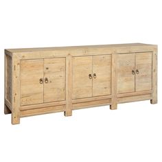 a wooden sideboard with four doors and three drawers