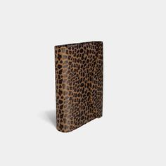 an animal print notebook on a white background, with the cover partially open to show it's pages