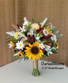 a bouquet of sunflowers and other flowers on a table