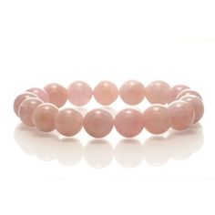 Madagascar Rose Quartz Stretch Bracelet 12mm Size Approx. 6 3/4" Rose Quartz is the pink variety of Quartz. Its colors range from a pastel pink to a rose pink hue, including orange and violet pink tones, which are believed to be caused by trace amounts of aluminum, phosphorous and manganese. While Rose Quartz can often be very opaque with just a hint of pink, Madagascar Rose Quartz is noted for its fine translucency (soft radiating inner glow); beautiful classic ‘rose’ hues with an almost lumine Pink Rose Quartz Round Stretch Bracelet, Pink Rose Quartz Stretch Bracelet, Pink Rose Quartz Stretch Bracelet With 8mm Beads, Elegant Pink Bracelets With 8mm Beads, Pink Rose Quartz Round Bracelet, Pink Bracelets With 8mm Round Beads, Orange And Violet, Inner Glow, Pink Tone