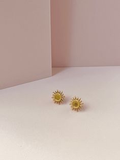 Minimalistic and Unique Stud Sun Earrings with 18k Gold plated findings.  Length: Approximately 1.4 Centimeters Materials used: - Nickel-free 18k Gold plated Studs Care instructions: - Treat with care - Avoid exposure to water and cosmetics as it may affect the longevity of the materials used - Avoid dropping or bending as it could cause to break - Wipe clean with a soft cloth Packaging: The product will be sent in a linen pouch and posted in a cardboard box. The packing is all made of paper and Minimalist Yellow Earrings For Pierced Ears, Minimalist Yellow Earrings For Gift, Minimalist Yellow Pierced Earrings, Yellow Minimalist Round Earrings, Yellow Pierced Earrings As A Gift, Yellow Pierced Earrings For Gift, Yellow Brass Earrings As A Gift, Handmade Yellow Gold-plated Earrings, Handmade Yellow Gold Plated Earrings