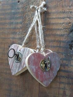 two wooden hearts hanging on a wall