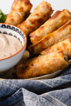 some food is sitting on a plate with dipping sauce