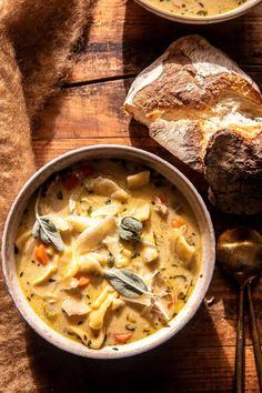 a bowl of pasta and bread on a wooden table