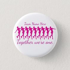 a badge with the words team name here together we're one in pink on it