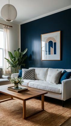 a living room with blue walls and white furniture