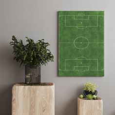 a green soccer field on the wall next to two planters