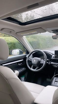 the interior of a car with dashboard, steering wheel and center console in front of it