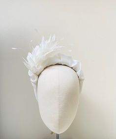 "FABRIC This Women's facinator headband is hand made from pure ivory crepe silk which I had been wrapped and stitched by hand around a padded headband. The embellishment is a stunning complementary coque feather with a quality hand stitched finish with no glued parts to ensure a luxurious and top quality finish. I only source sustainable silk fabrics which are not only kind to your hair due to the nourishing quality that silk has but also kind to the planet. I do not use satins, polyesters visco White Fascinator With Feather Trim For Races, Fitted White Fascinator With Feathers, White Adjustable Fascinator With Feather Trim, Cream Feathered Wedding Fascinator, Luxury White Feather Fascinator, Luxury Headbands, Hair Due, Stretch Headband, Padded Headband