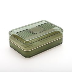 a green rectangular container with a lid on a white surface, showing the top portion of it