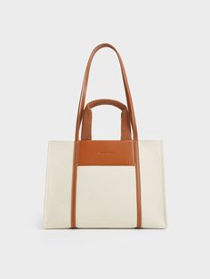 If you don't like to travel light, then our large-sized Shalia tote bag is for you. Featuring a refreshing cognac-and-beige finish, double top handles, and a roomy interior, this boxy canvas tote is all class and elegance. While the zip closure keeps your belongings safe and secure, the non-adjustable strap gives you the option of going hands-free. On work days, let this bag be the finishing touch to a neutral shade midi dress and a belted blazer. Luxury Tote Bags, Blue Tote, Work Tote, Charles Keith, Work Bag, Bag Handle, Travel Tote, Perfect Bag, Everyday Bag