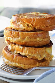 a stack of pancakes sitting on top of a white plate