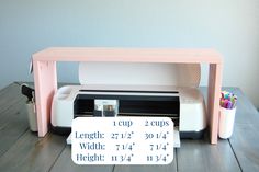 a pink desk with a sign that says, i cup 2 cups width and height