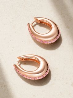 Designer Ananya Malhotra’s Indian heritage and spiritual upbringing inspire ANANYA's striking pieces. Cast from 18-karat rose gold, these 'Chakra Icon' hoop earrings are defined by a sleek, chunky profile traced by a channel of round-cut pink sapphires. Pair yours with the matching bracelet in our edit. Traditional Rose Gold Earrings For Formal Occasions, Luxury Rose Gold Teardrop Earrings, Rose Gold Plated Drop Earrings, Rose Gold Polished Drop Earrings, Formal Rose Gold Plated Hoop Earrings, Rose Gold Fusion Jewelry For Formal Occasions, Rose Gold Fusion Formal Jewelry, Formal Fusion Rose Gold Jewelry, Formal Fusion Style Rose Gold Jewelry