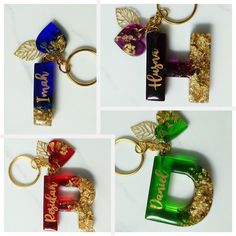 four different colored keychains with gold leaves and name tags on them, each featuring the letter d