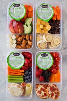 four plastic containers filled with different types of food including fruit, vegetables and meats