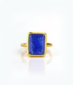 This beautiful bezel set ring is made with large rectangular faceted natural Blue Jade in 18K Vermeil Gold. The ring has a 925 stamp. Gemstone size is 13 x 18 mm. Please specify your size at checkout. Since I use natural gemstones, the stones may vary slightly in color, shape and size. Due to the nature of this stone there are natural inclusions and small internal cracks. This ring is available in two finishes: ✦ 18K VERMEIL GOLD ✦ BRIGHT STERLING SILVER Please leave me a note at checkout which Jade Gemstone Ring With Round Stone, Rectangular Cabochon Yellow Gold Ring, Gold Jade Ring With Polished Finish, 14k Gold Turquoise Cabochon Ring, Yellow Gold Jade Cabochon Ring, Ring Rectangle, Rectangle Ring, Gold Stacking Ring, Blue Jade