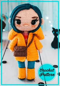 a crocheted doll is wearing a yellow jacket and blue pants, holding a brown purse