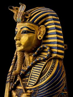 an egyptian statue is shown in gold and blue stripes on the head, with a black background