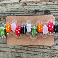 a row of glass beads sitting on top of a wooden table