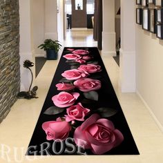 a long black and pink carpet with roses on it