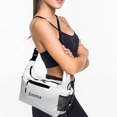 a woman in black sports bra and leggings is holding a white gym bag