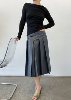 The Sammie, a low rise waxy pleated midi skirt. Featuring a raw edge finished with a single stay stitch and an invisible side seam zipper. Sizing runs slightly large due to low rise fit. Size down for a mid rise/high rise fit. Chic Midi Skort With Pleated Details, Low Rise Pleated Skirt, Stretch Cotton Mid-rise Mini Skirt, Non-stretch Midi Pleated Skirt, Relaxed Midi-length Pleated Skirt With Lining, Pleated Midi Skirt, Raw Edge, Low Rise, Mid Rise