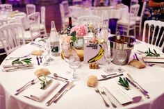 the table is set with silverware, wine glasses and napkins for guests to enjoy