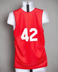 "Reversible red and white basketball jersey tank. One side red and one side white. Number 42 on the back. Alleson Athletic size - S laying folate: pit to pit - 18.5\" vintage pre-owned" College Team Spirit Sleeveless Jersey, Sleeveless College Jersey With Team Spirit Style, Sleeveless Collegiate Jersey For Game Day, Collegiate Sleeveless Jersey For Team Events, Sleeveless Team Jersey For Team Events, Sleeveless Team Jersey For Sports Events, Team Spirit Red Sleeveless Tops, Team-colored Sleeveless Jersey For Sports Events, Collegiate Sleeveless Jersey For Sports Events