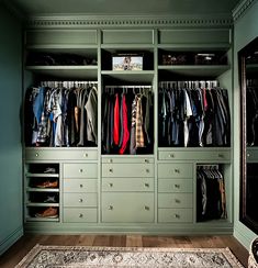 an organized closet with green walls and drawers