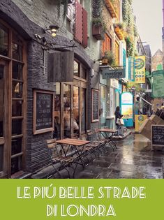 an alleyway with tables and chairs on the sidewalk in front of buildings that have french writing on them