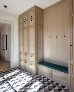 an empty room with wooden cabinets and black and white checkered flooring on the floor